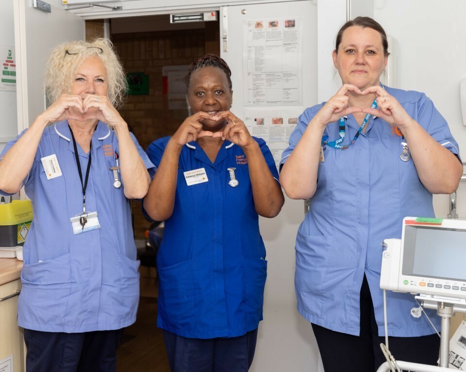 staff making the heart sign