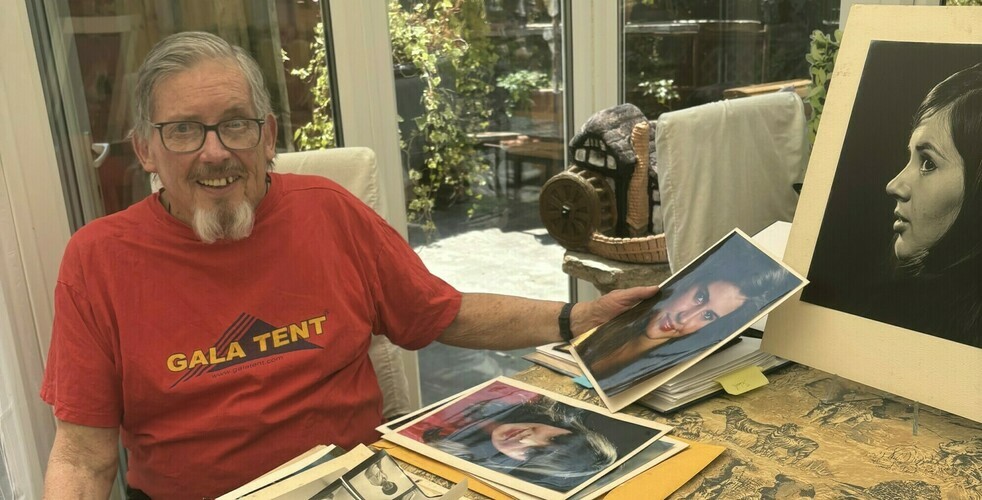 Don with his collection of photos edited (cropped)
