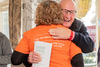 Photo of an OrangeLine volunteer supporting a man